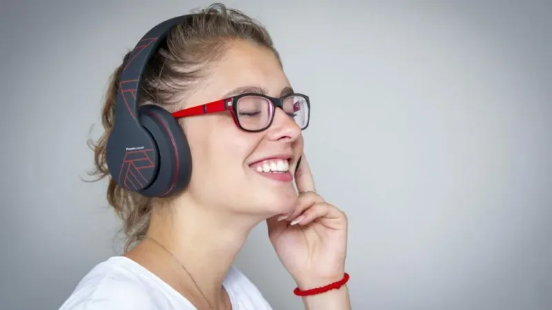 PowerLocus wireless headphones displayed on a desk setup